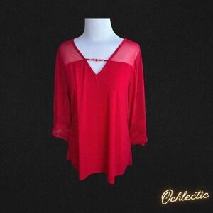 Red mesh top with sheer details and V-neckline, featuring 3/4 sleeves